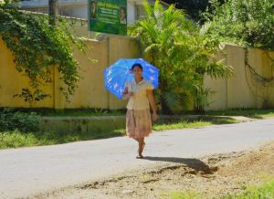 women often used umbrellas while walking to shield themselves from the sun
