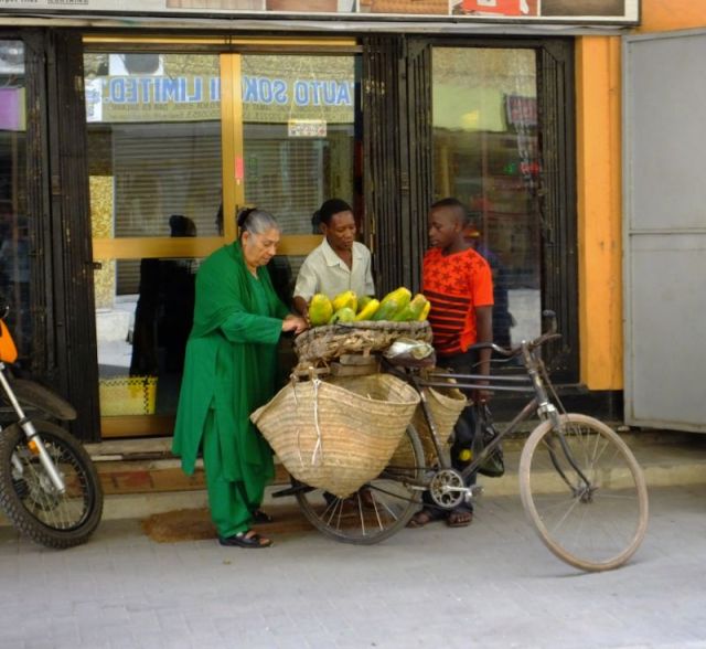 Woman bargaining for melons in Dar