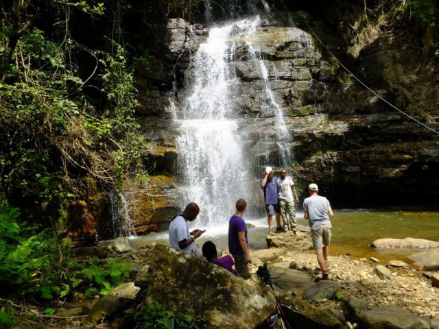 Some of the crew at the base of the waterfall