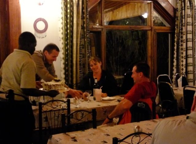 A fuzzy photo of the anniversary cake and couple.