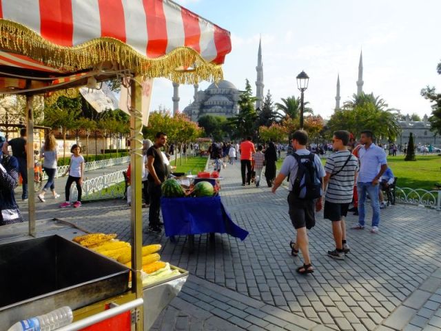 Vendors selling sweet corn and watermelon