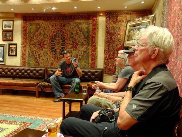 Inside the Turkish carpet store watching the presentation of carpets.