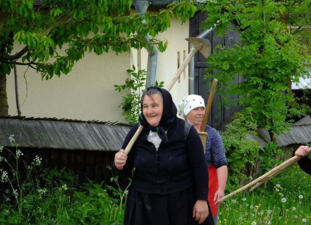Two of the three women hitching a ride in the wagon