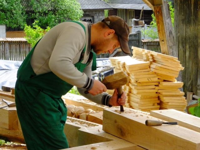 Busy carving a wooden plank