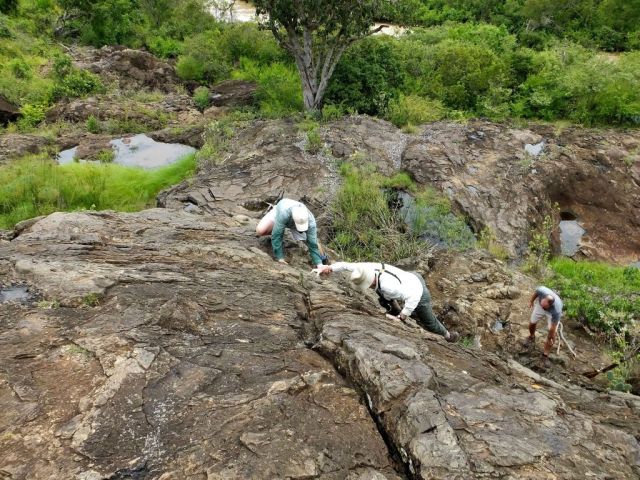 Paul climbing up the rock face. It is steeper than it looks in the photo