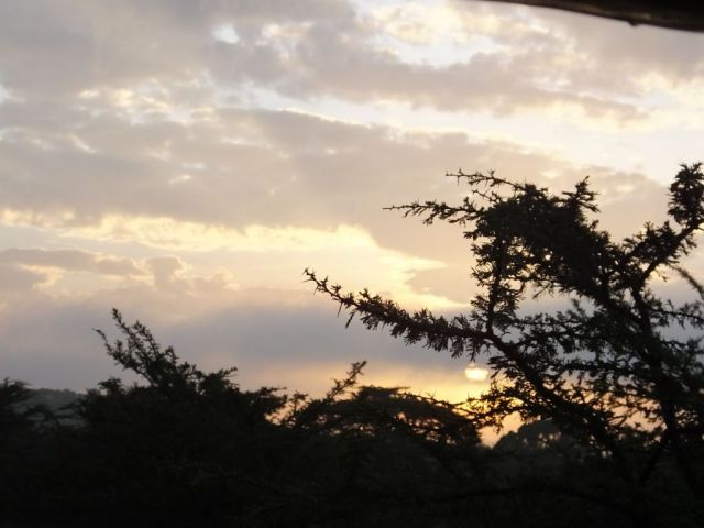 A partly cloudy sunrise in the Mara