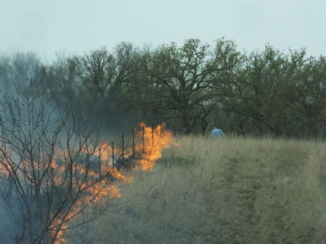 Paul starting fire with a drip torch