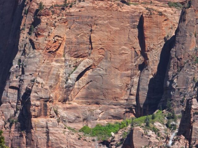 Can you see a mans face and his pointing finger? Hint his thumb is covering his nose, there is a distinct eye and his ear is above the small opening to the cave. Good luck