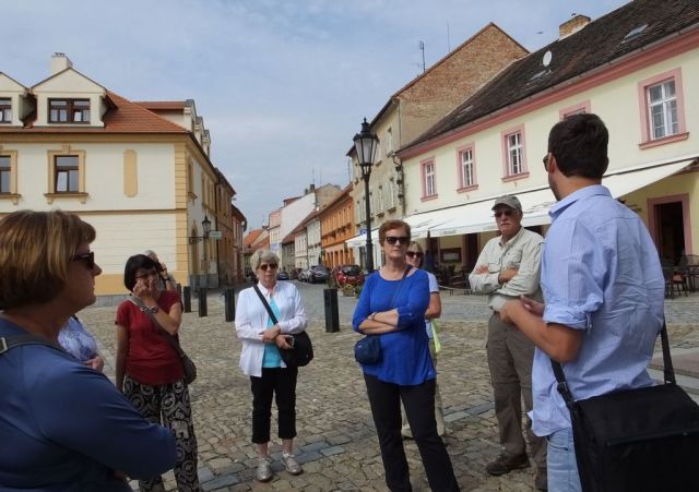 Listening intently to Milan in front of the Parish church.