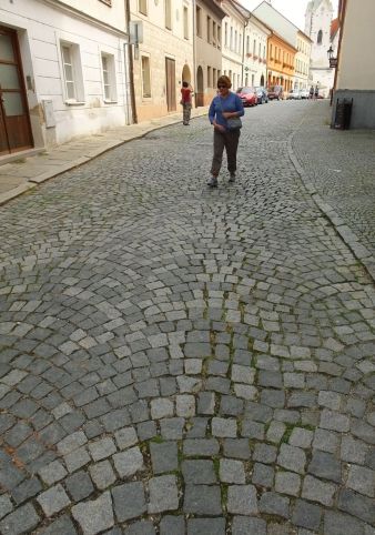 I tried to show the artful pattern of the cobblestone street Jennifer is walking down. It is easier to see in real life!