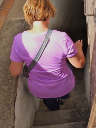 Jennifer starting back down the stairs through the narrow passages.