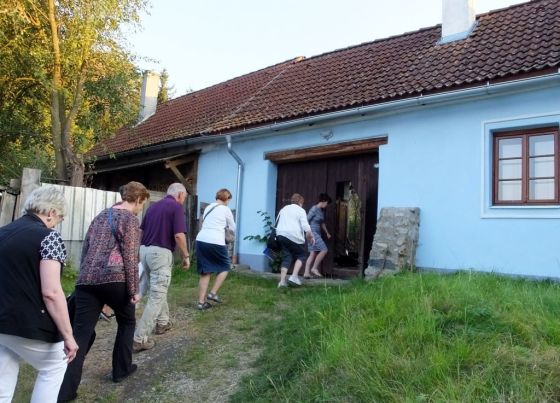 Our group filing through the door into the back yard of our hosts house.