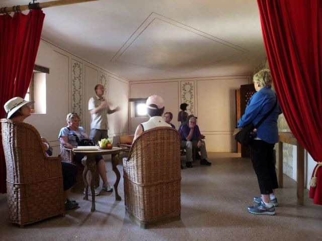 Sitting in the restored room of a Roman house