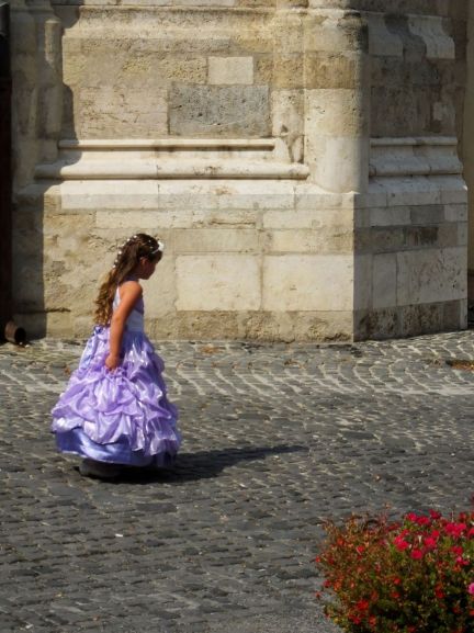 Little girl dressed in a fancy purple dress. How cute is that.